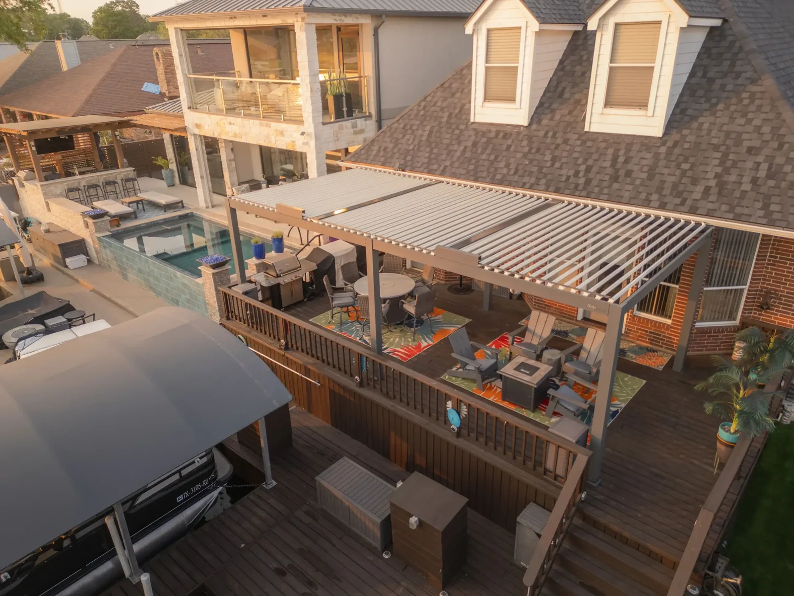 Louvered pergola with open roof slats installed over a residential deck