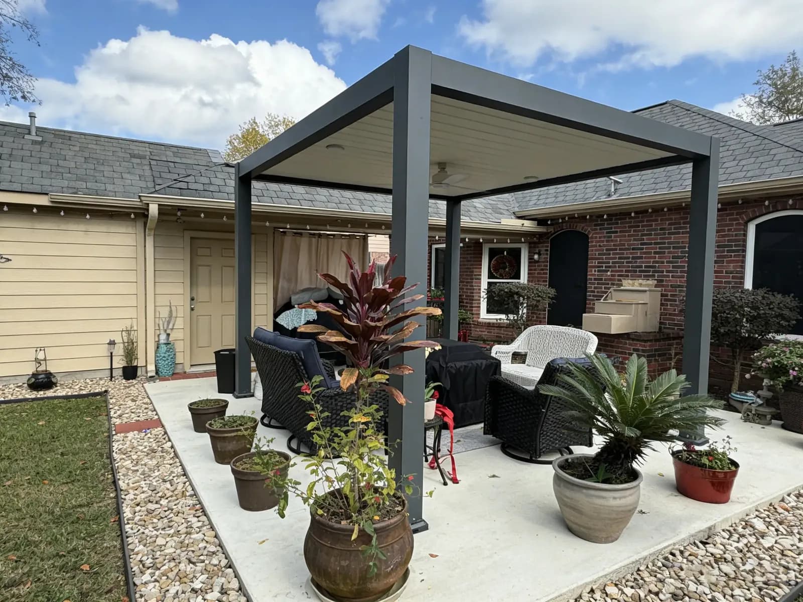 Freestanding aluminum pergola over a patio seating area